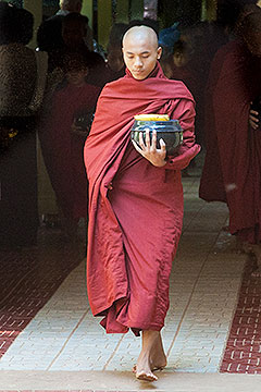 Monk walking with bowl