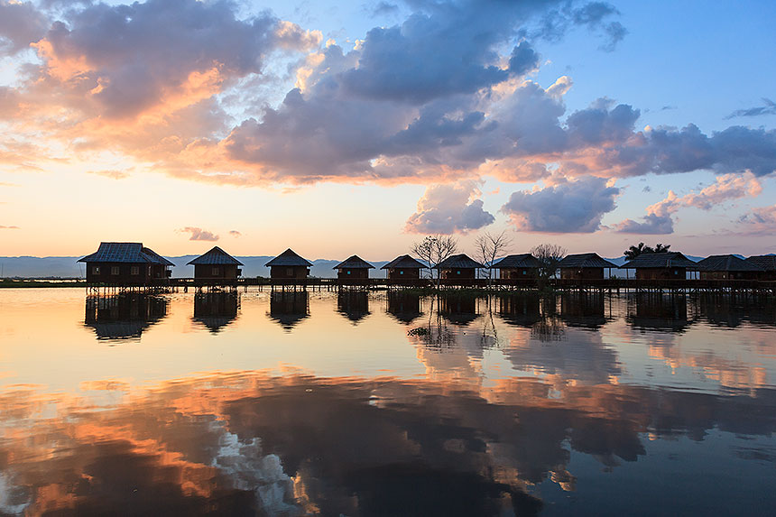 sunset beyond cottages