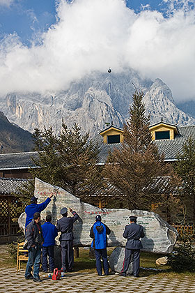 Soldiers painting sign on rock