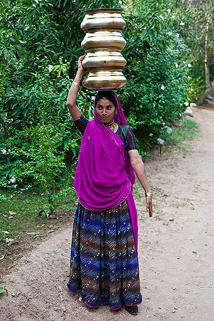 Woman balancing pots