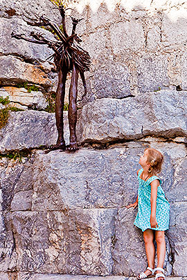 Child looks at sculpture